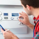 Technician servicing heating boiler